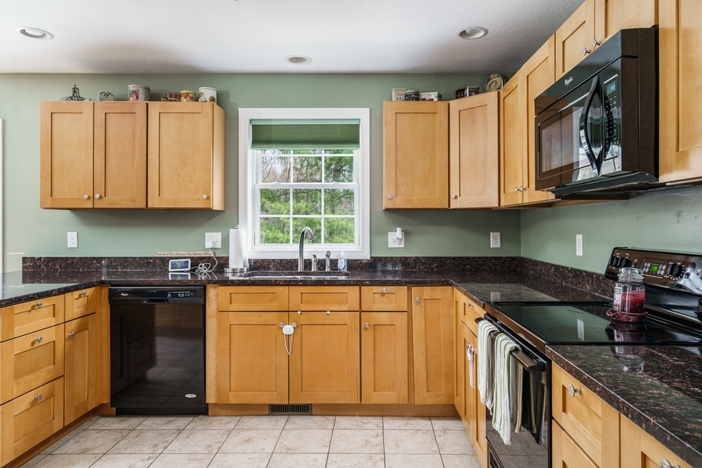 195 Brickyard Road Southampton, MA 01073 - Photo 15 of 42 a kitchen with granite countertop cabinets stainless steel appliances a sink and a window