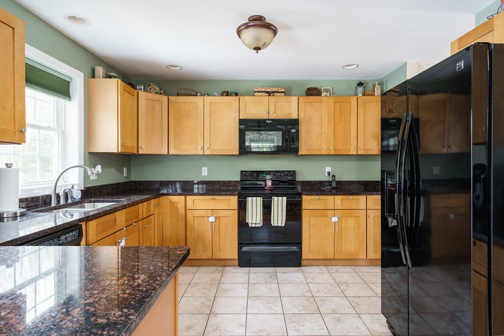 195 Brickyard Road Southampton, MA 01073 - Photo 16 of 42 a large kitchen with stainless steel appliances granite countertop a refrigerator a stove a sink a counter top space and cabinets