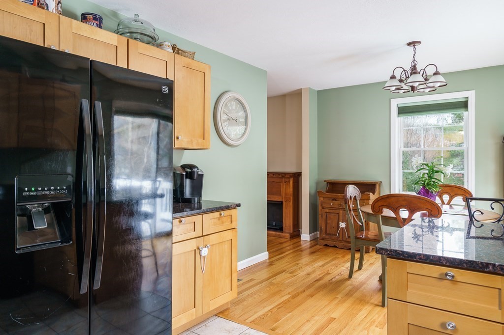 195 Brickyard Road Southampton, MA 01073 - Photo 17 of 42 a kitchen with stainless steel appliances granite countertop a refrigerator a stove and a sink with wooden floor