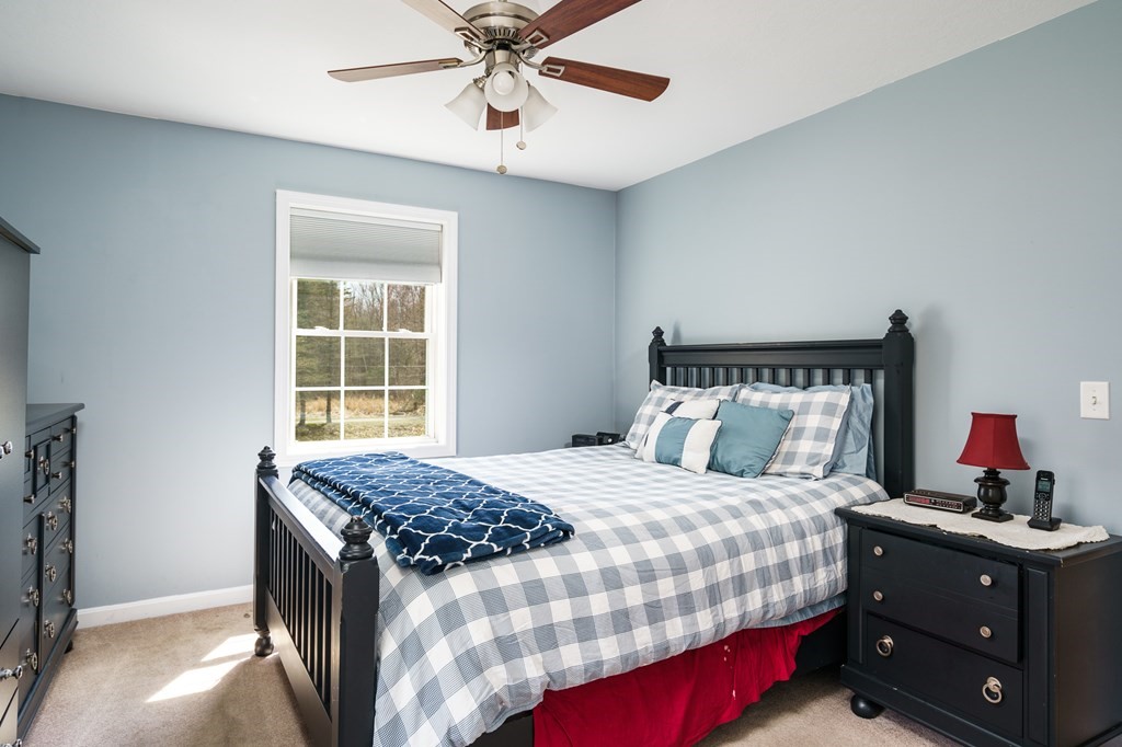 195 Brickyard Road Southampton, MA 01073 - Photo 21 of 42 a bedroom with a bed and a chandelier