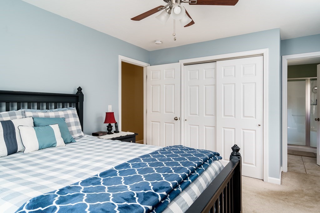 195 Brickyard Road Southampton, MA 01073 - Photo 22 of 42 a bedroom with a large bed and a chandelier