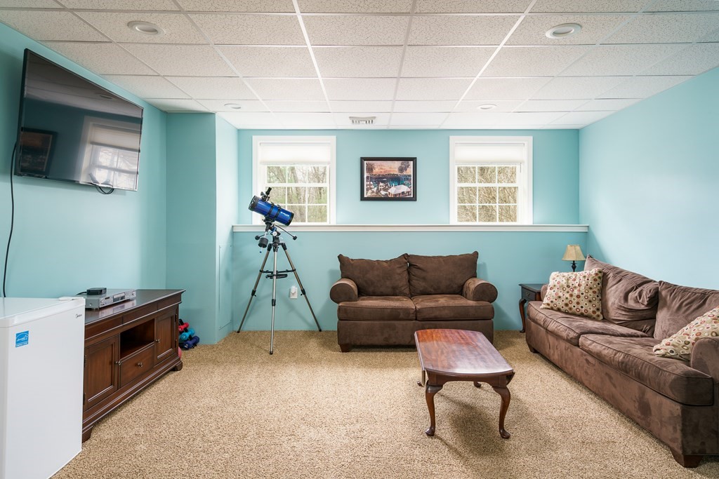 195 Brickyard Road Southampton, MA 01073 - Photo 27 of 42 a living room with furniture a flat screen tv and a window