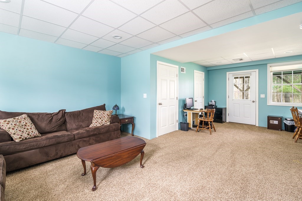 195 Brickyard Road Southampton, MA 01073 - Photo 28 of 42 a living room with furniture and a gym machine