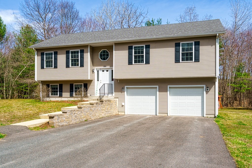 195 Brickyard Road Southampton, MA 01073 - Photo 3 of 42 a front view of a house with a yard and garage