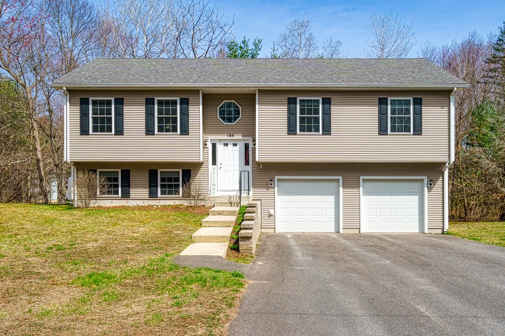 195 Brickyard Road Southampton, MA 01073 - Photo 4 of 42 a front view of a house with a yard and garage