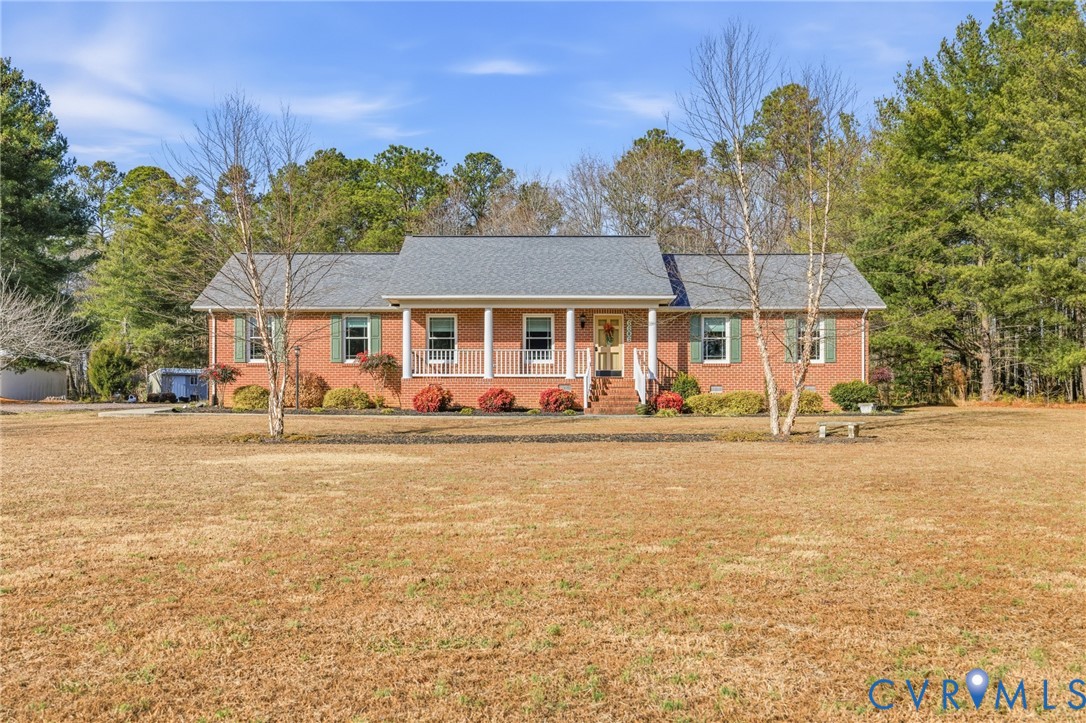 6606 West Quaker Road Disputanta, VA 23842 - Photo 1 of 32 View of front of house with a porch, a front yard,