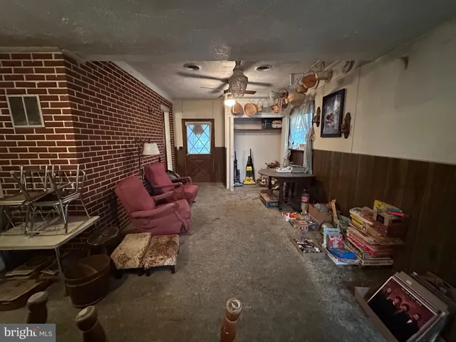 a living room with furniture and a mirror