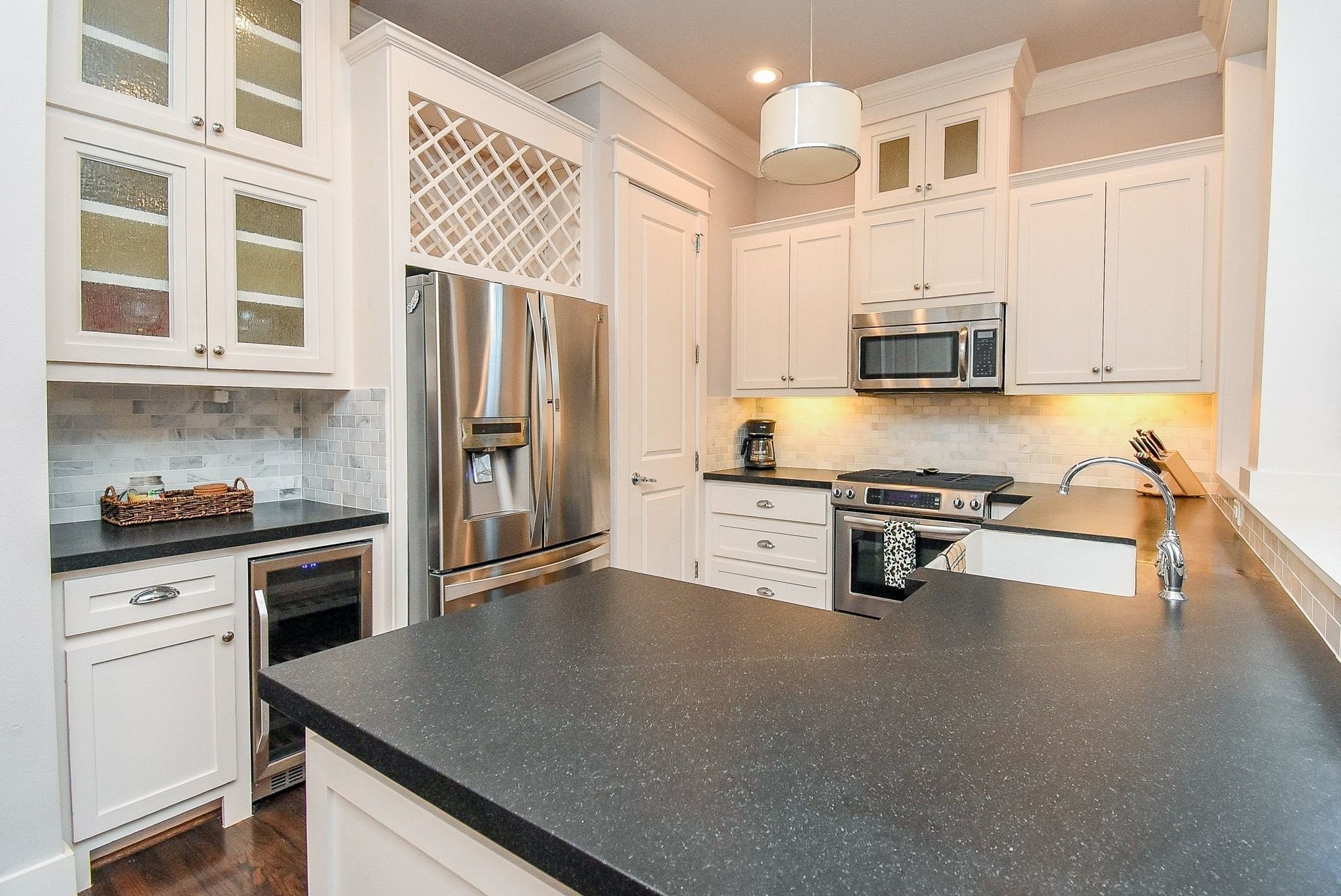 1036 Kern Street Houston, TX 77009 - Photo 14 of 47 Honed granite countertops, custom site-built cabinets, marble backsplash, and undercabinet lighting are but a few of the standout features in this Kitchen.