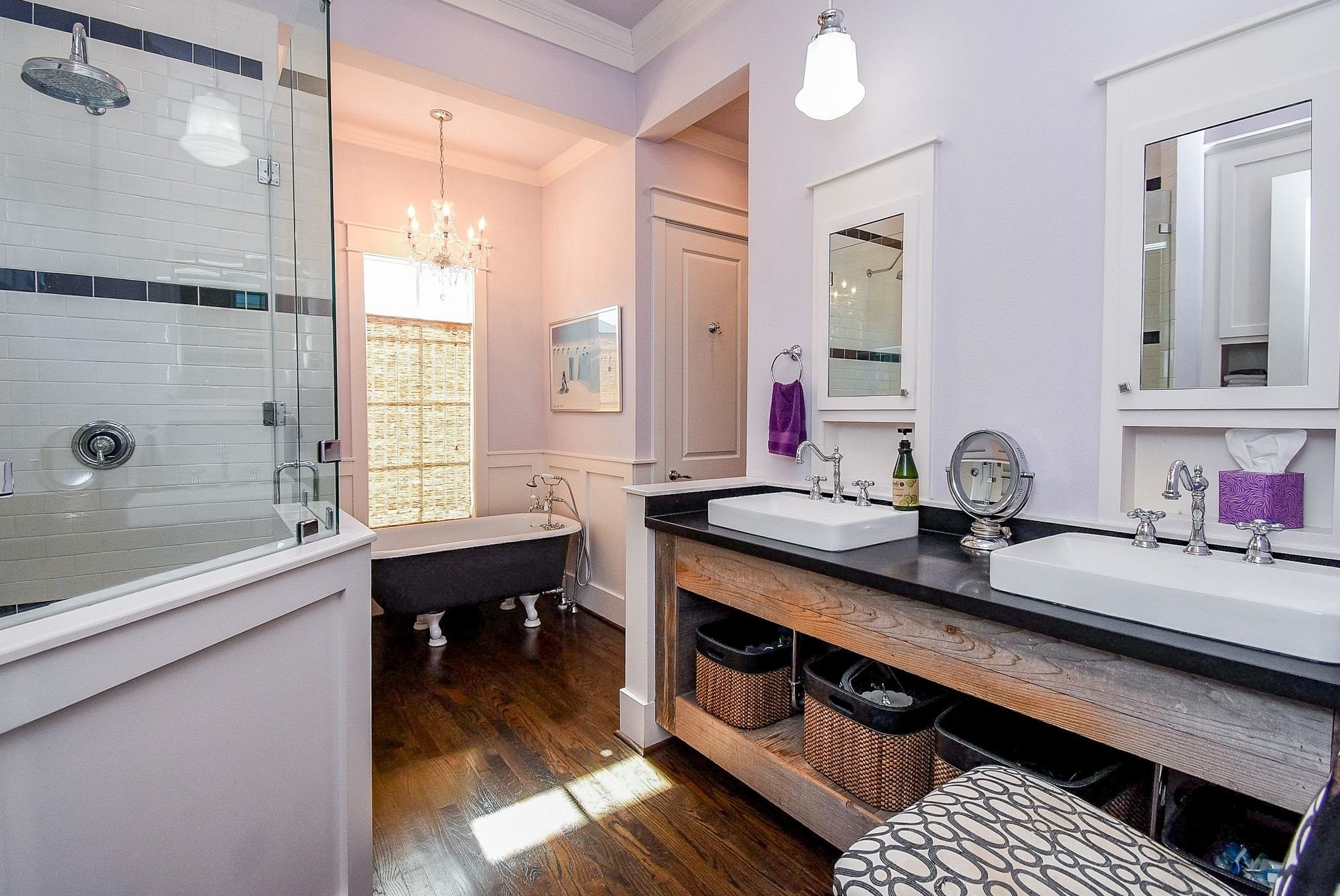 1036 Kern Street Houston, TX 77009 - Photo 29 of 47 Your view upon entering the Primary Bathroom. On the right is your vanity with dual sinks & mirrored medicine cabinets. On the left is your walk-in tiled shower. Ahead is your clawfoot soaking tub with beautiful chandelier. Next to that is the private water closet, and opposite that is your enormous walk-in clothes closet!