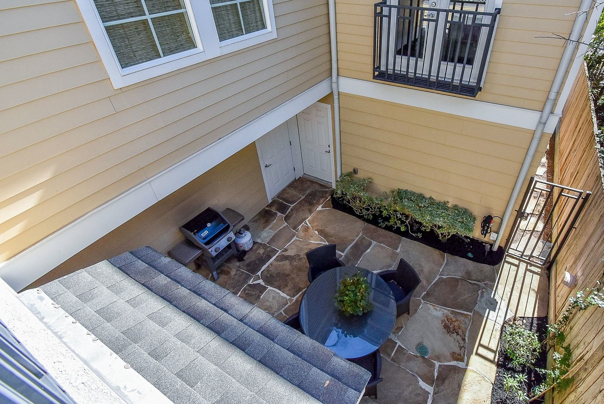 1036 Kern Street Houston, TX 77009 - Photo 39 of 47 This is your view into the courtyard from the upstairs covered balcony. You can see the Juliet balcony off the Primary Suite across the way.