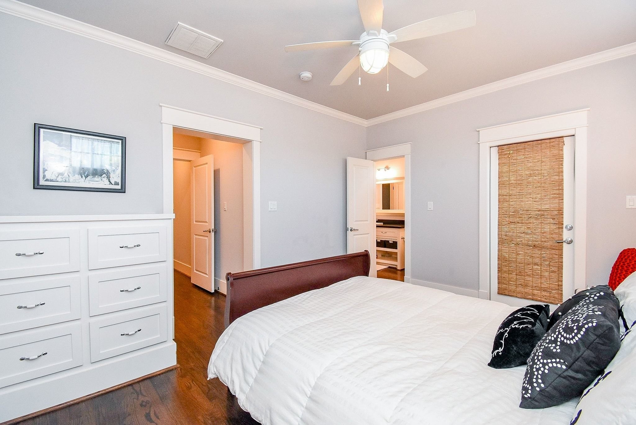 1036 Kern Street Houston, TX 77009 - Photo 45 of 47 An alternate view of the 3rd bedroom looking out towards the hallway or into the bathroom. The dresser on the left is built in and stays with the house. The door on the right exits to a small covered balcony area. There is also a huge walk-in closet on the left as you are leaving this particular bedroom.