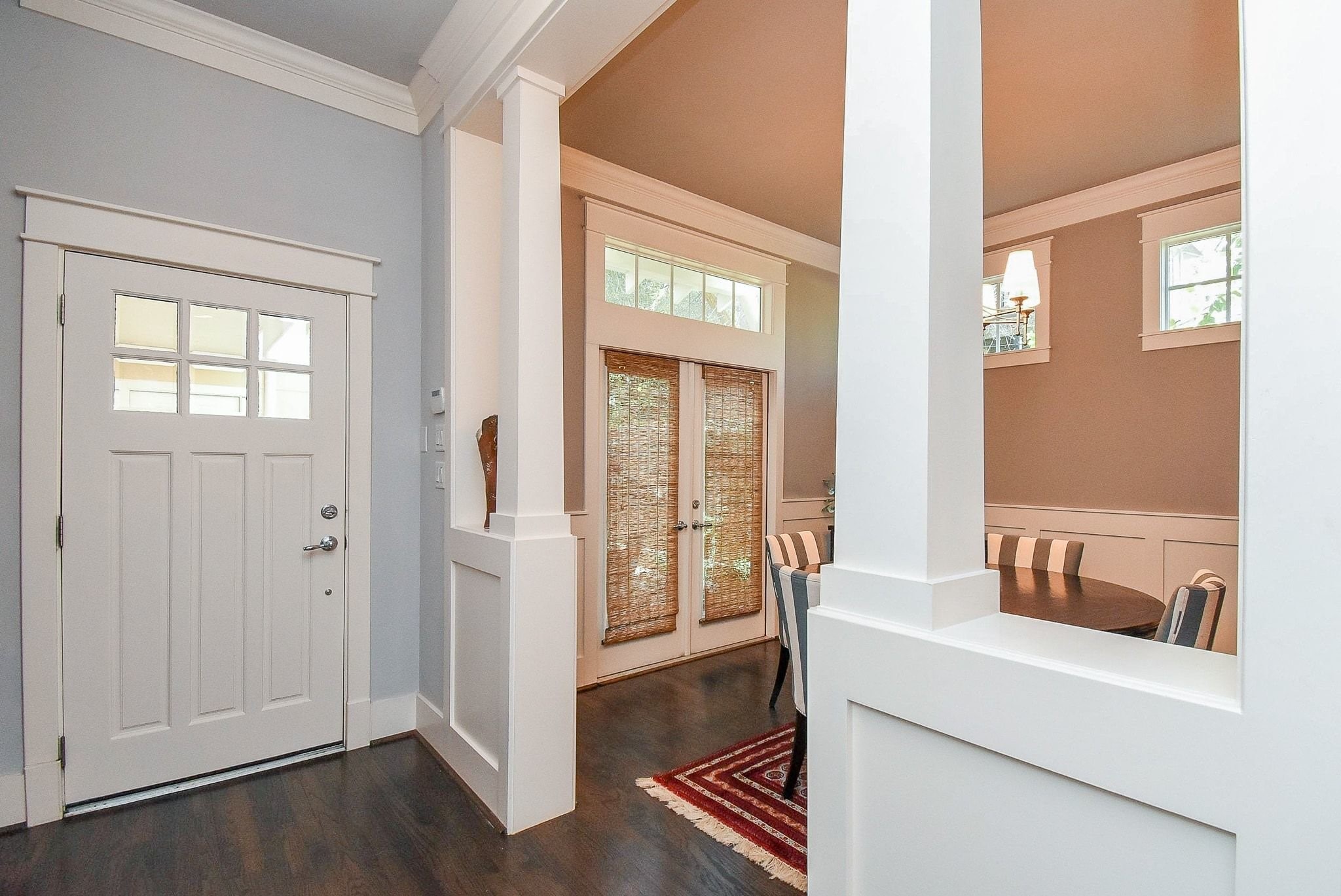 1036 Kern Street Houston, TX 77009 - Photo 9 of 47 Looking back towards the front door and into the Dining Room. The first thing you might notice is the exquisite millwork throughout this entire home. The floor & ceiling crown mouldings, window trim detail, and wainscoting are not offered or found in most homes in this price range. A set of French Doors, with custom woven shades, open to the courtyard area, allowing you to bring the outdoors in when you have occasion to.