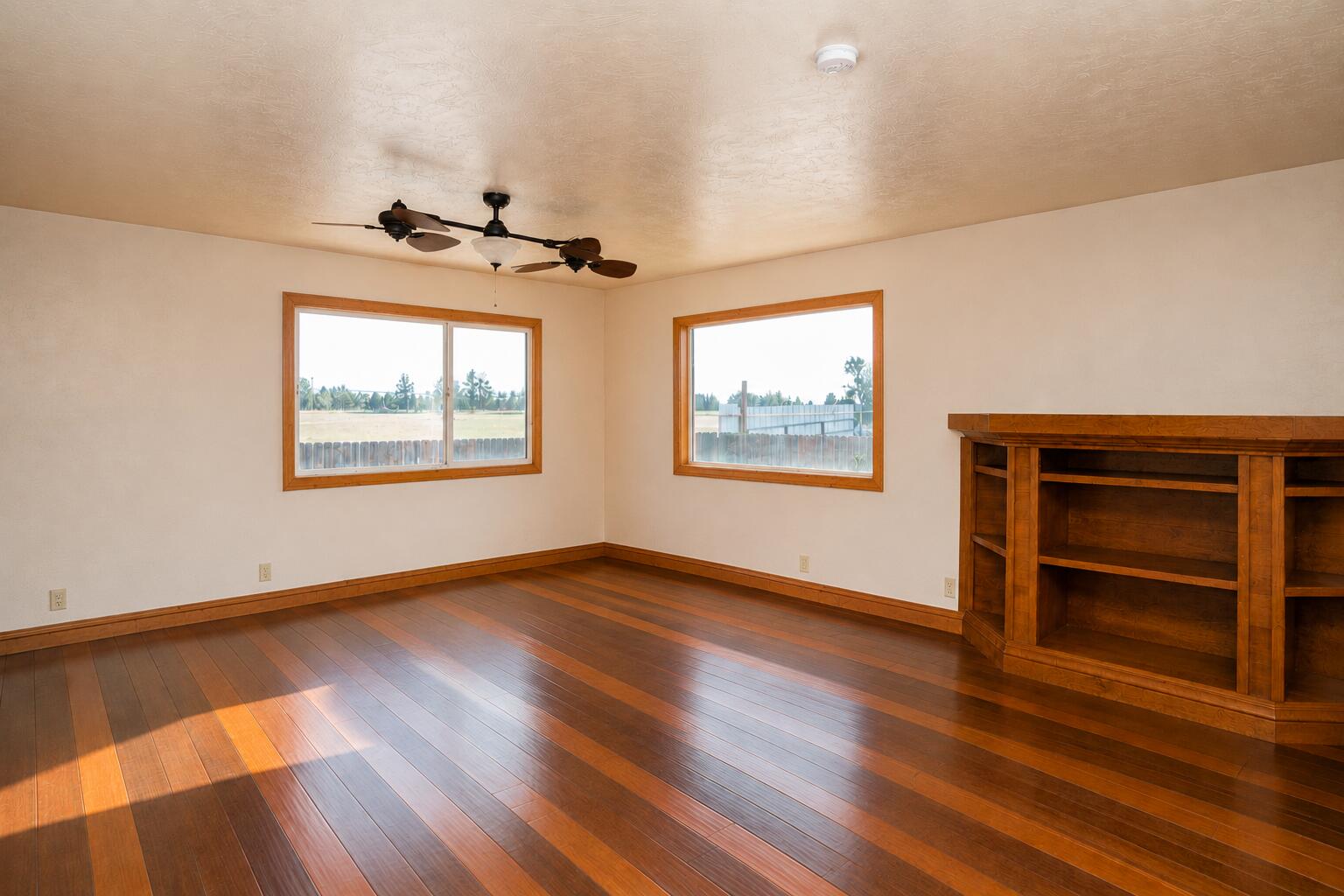 26695 Horsell Road Bend, OR 97701 - Photo 16 of 33 a view of an empty room with a window and wooden floor