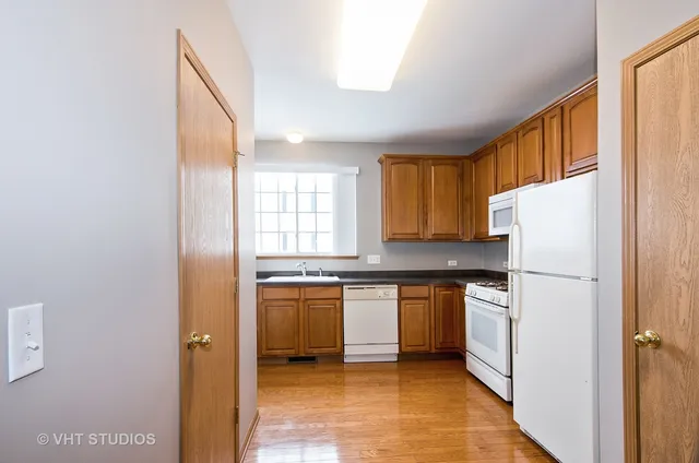 a kitchen with stainless steel appliances a refrigerator sink and cabinets