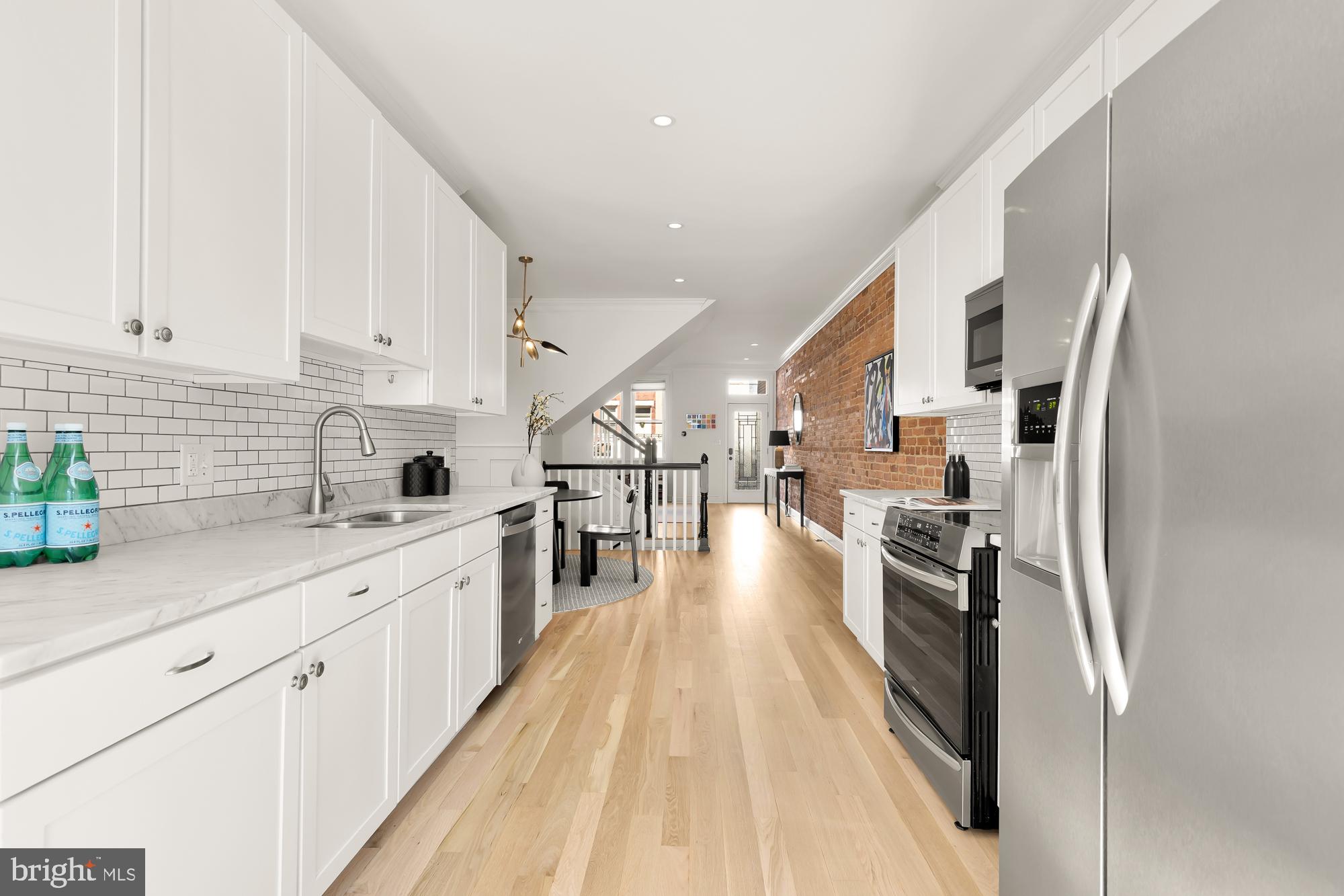 316 Elm Street Northwest Washington, DC 20001 - Photo 13 of 43 a kitchen with stainless steel appliances a sink a stove and a refrigerator