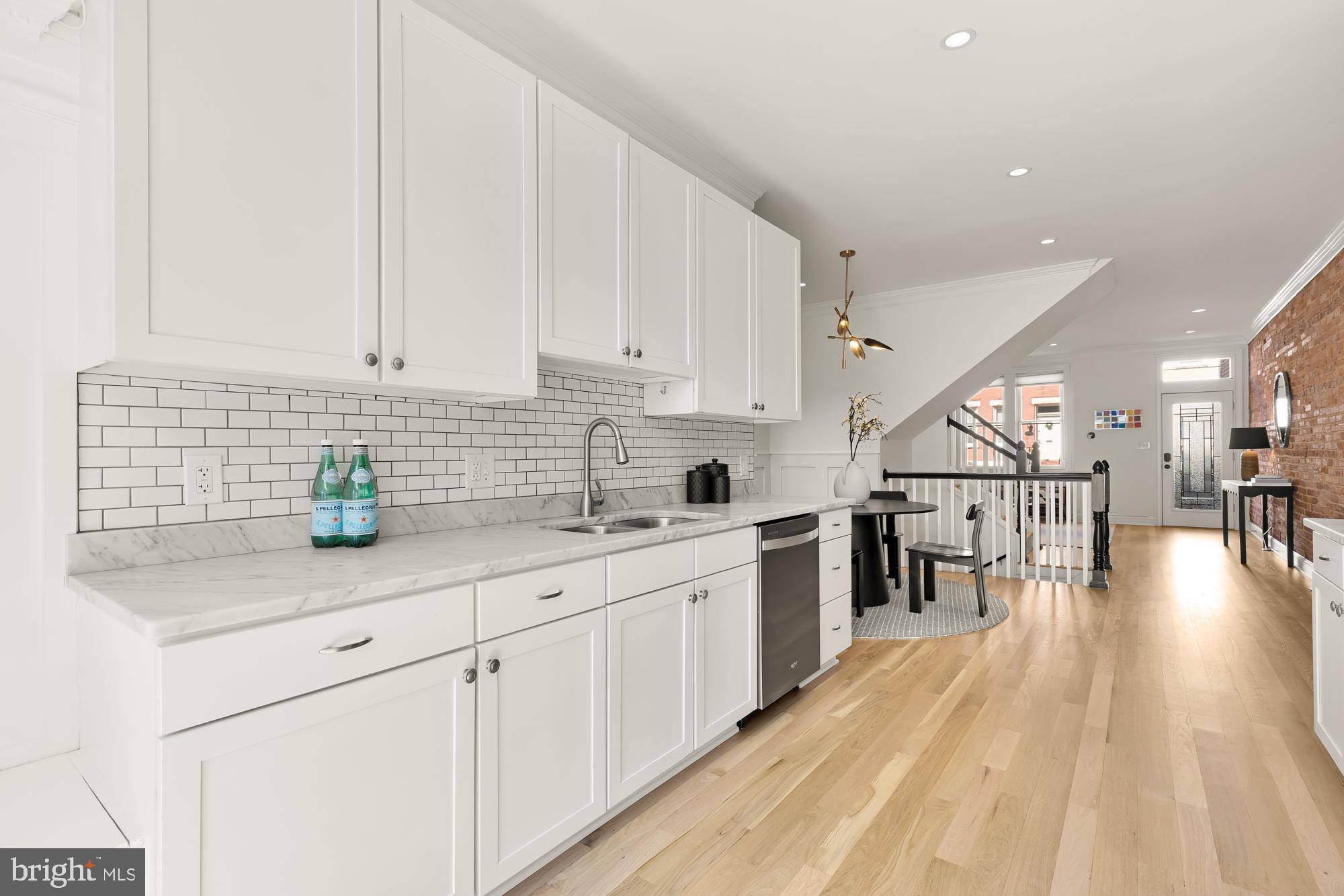 316 Elm Street Northwest Washington, DC 20001 - Photo 14 of 43 a kitchen with stainless steel appliances granite countertop a sink a stove top oven a chimney and cabinets