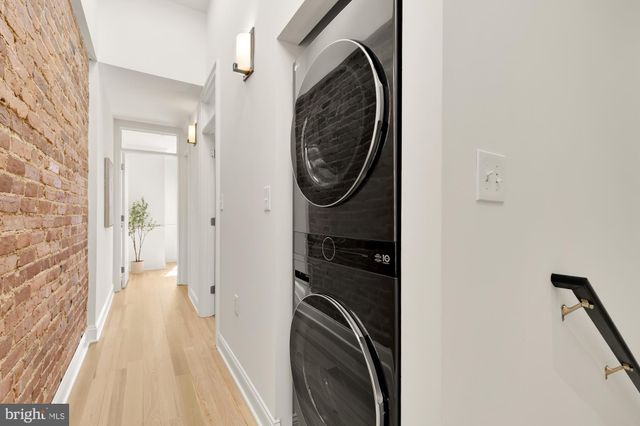 a bedroom with a bed lamp and a window