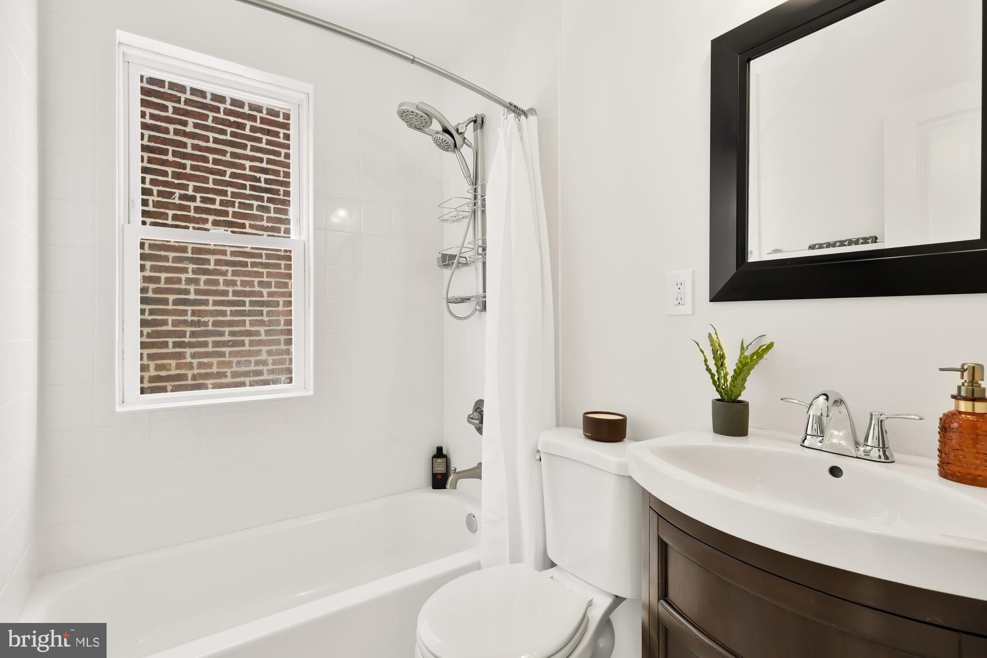 316 Elm Street Northwest Washington, DC 20001 - Photo 29 of 43 a bathroom with a sink a toilet and shower