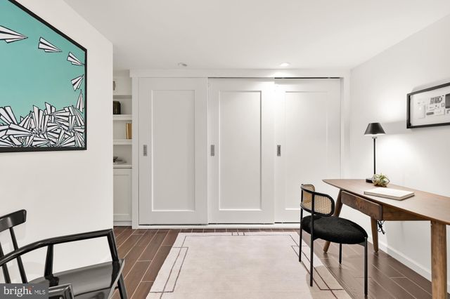 a workspace with wooden floor and a potted plant