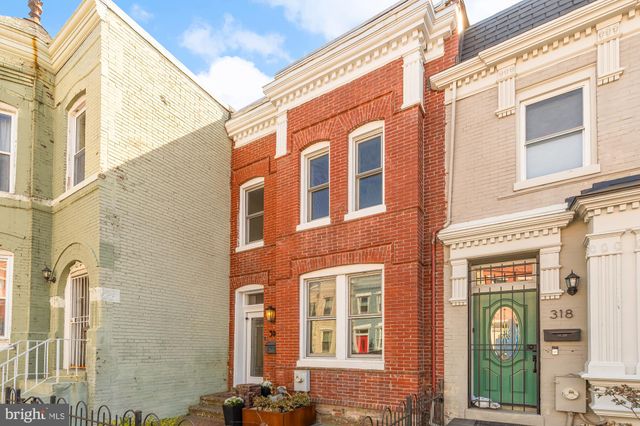 a view of a brick building with many windows