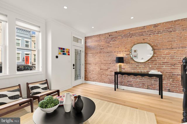 a living room with furniture a clock and a rug