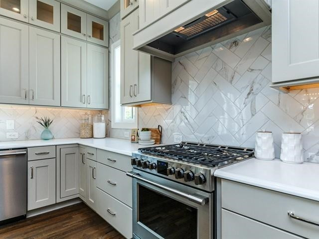 1017 Whitehall Circle Durham, NC 27713 - Photo 12 of 25 a kitchen with stainless steel appliances a stove and a sink