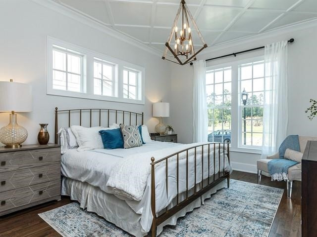 1017 Whitehall Circle Durham, NC 27713 - Photo 16 of 25 a bedroom with a bed and a chandelier