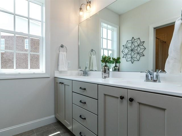 1017 Whitehall Circle Durham, NC 27713 - Photo 23 of 25 a bathroom with double sink and a mirror