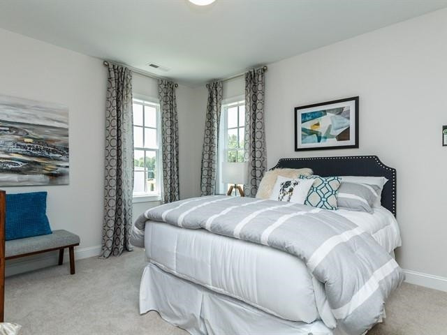 1017 Whitehall Circle Durham, NC 27713 - Photo 25 of 25 a bedroom with a bed a couch and windows