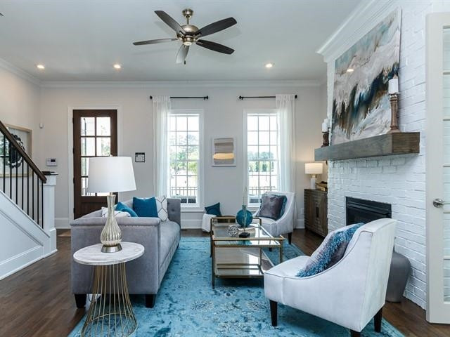 1017 Whitehall Circle Durham, NC 27713 - Photo 4 of 25 a living room with furniture a fireplace and a table