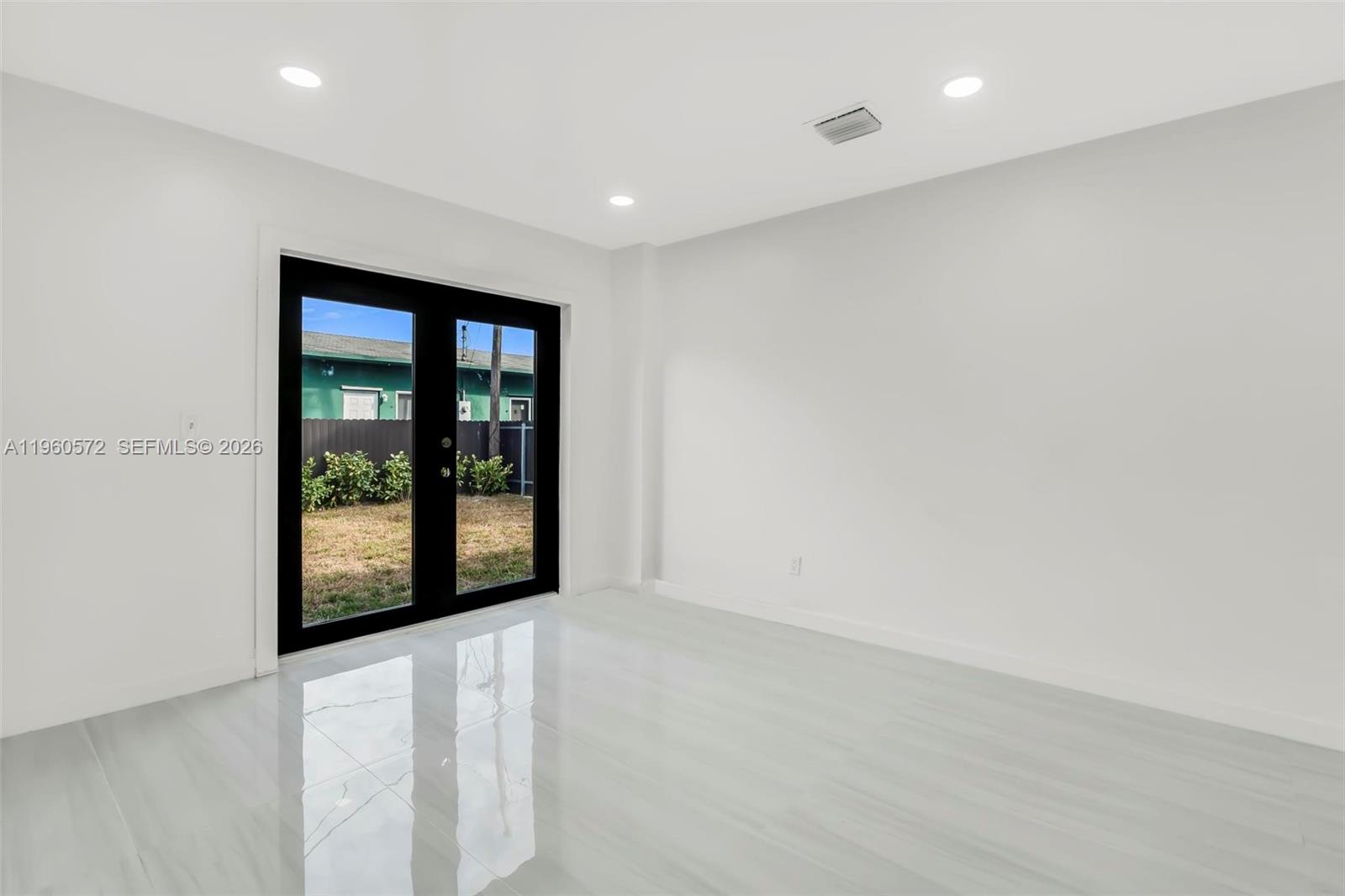 528 Northwest 3rd Court Hallandale Beach, FL 33009 - Photo 11 of 25 an empty room with window