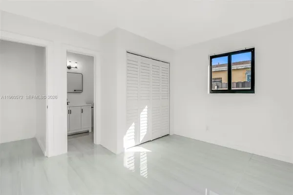 an empty room with a bathroom and a sink