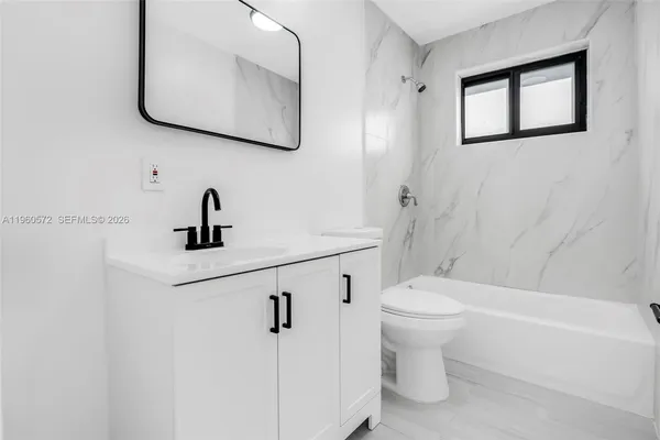 a bathroom with a toilet sink and a bathtub