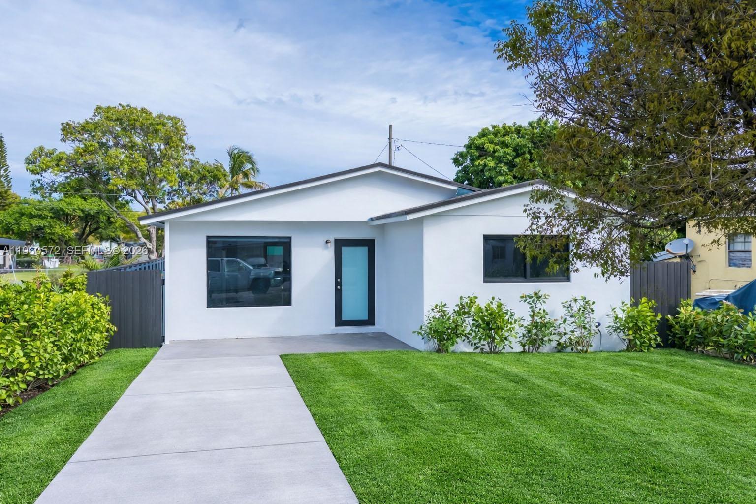 528 Northwest 3rd Court Hallandale Beach, FL 33009 - Photo 21 of 25 a front view of a house with garden
