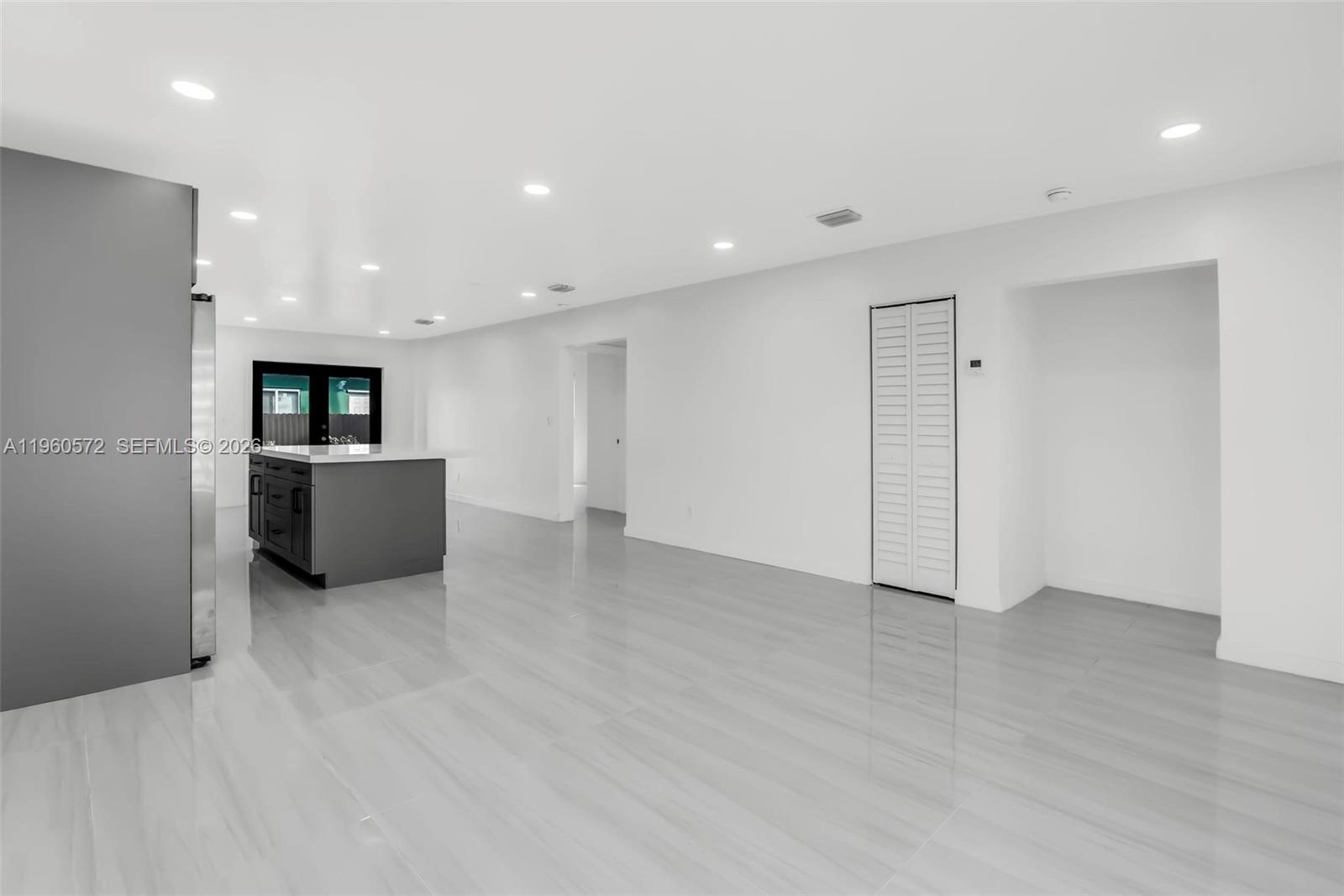 528 Northwest 3rd Court Hallandale Beach, FL 33009 - Photo 9 of 25 a view of a big room with wooden floor and windows