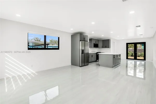 a view of kitchen with stainless steel appliances cabinets