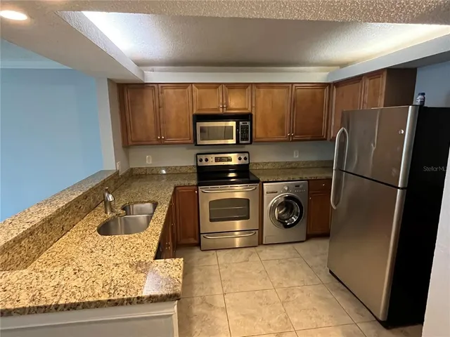 a kitchen with a refrigerator and a sink