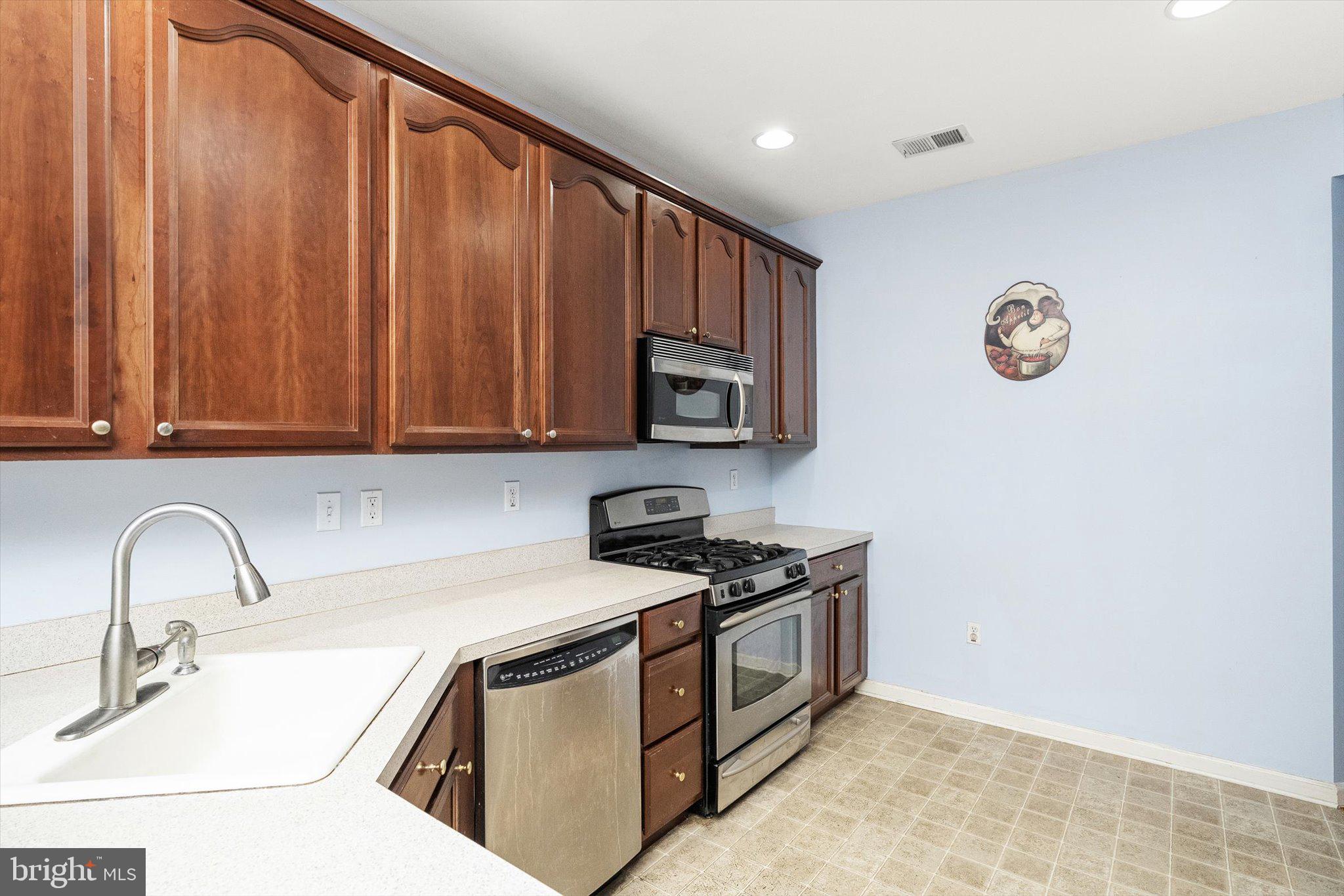 24 Blake Drive Pennington, NJ 08534 - Photo 14 of 28 a kitchen with stainless steel appliances granite countertop a sink stove and microwave