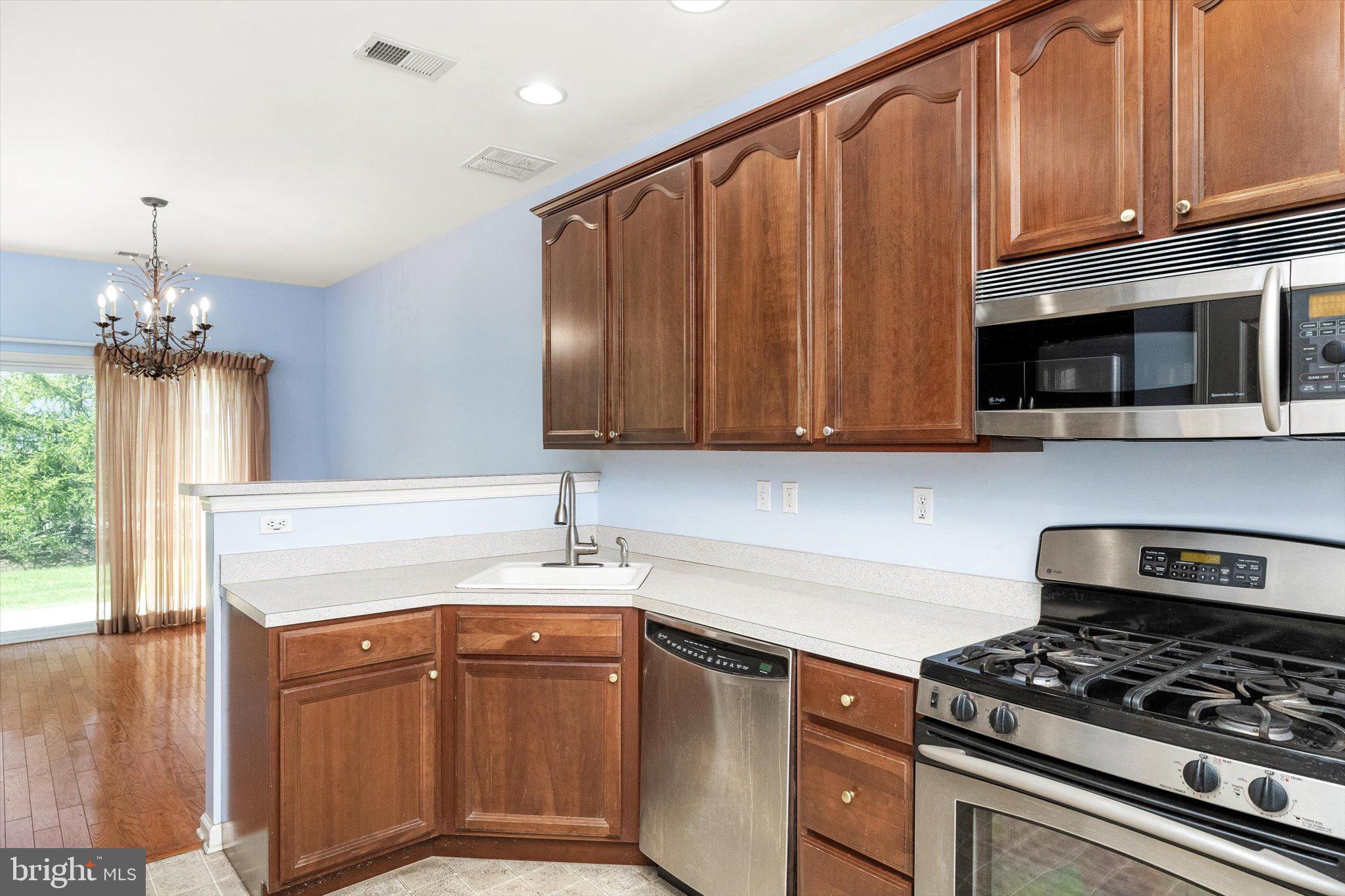 24 Blake Drive Pennington, NJ 08534 - Photo 15 of 28 a kitchen with stainless steel appliances granite countertop a sink stove and microwave