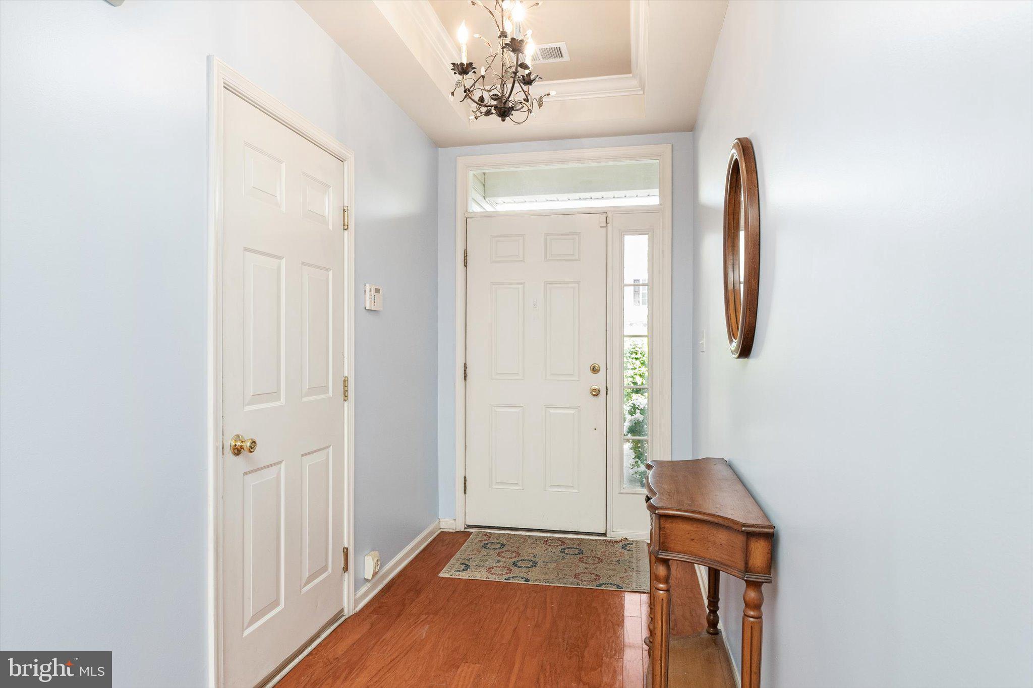 24 Blake Drive Pennington, NJ 08534 - Photo 5 of 28 a view of a hallway with entryway wooden floor and front door