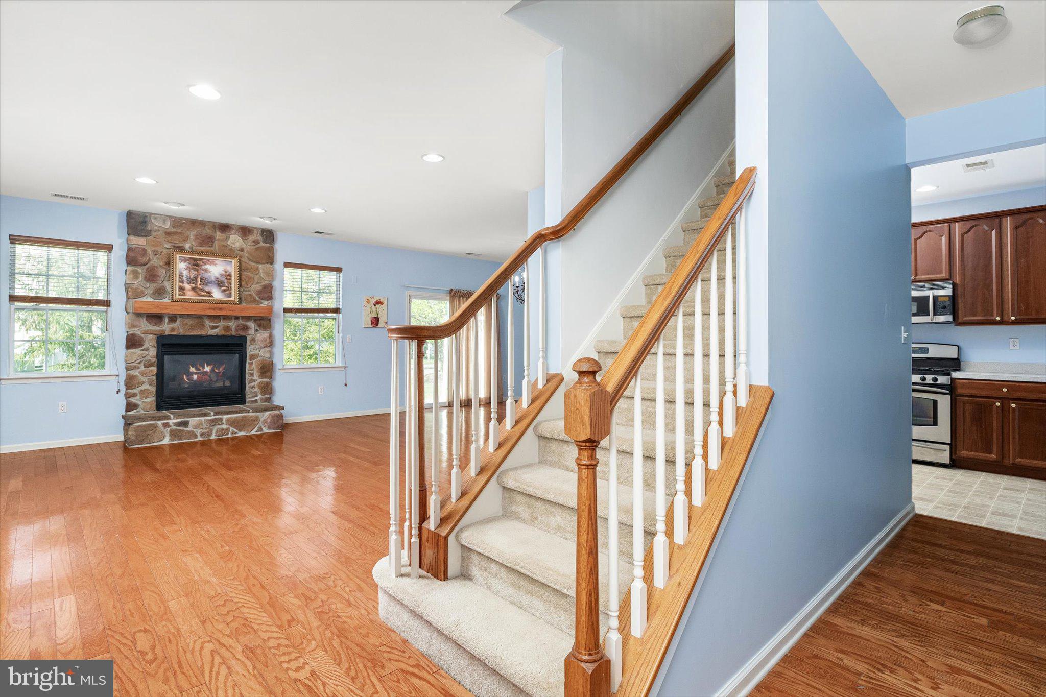 24 Blake Drive Pennington, NJ 08534 - Photo 6 of 28 a view of an empty room with wooden floor fireplace and a window
