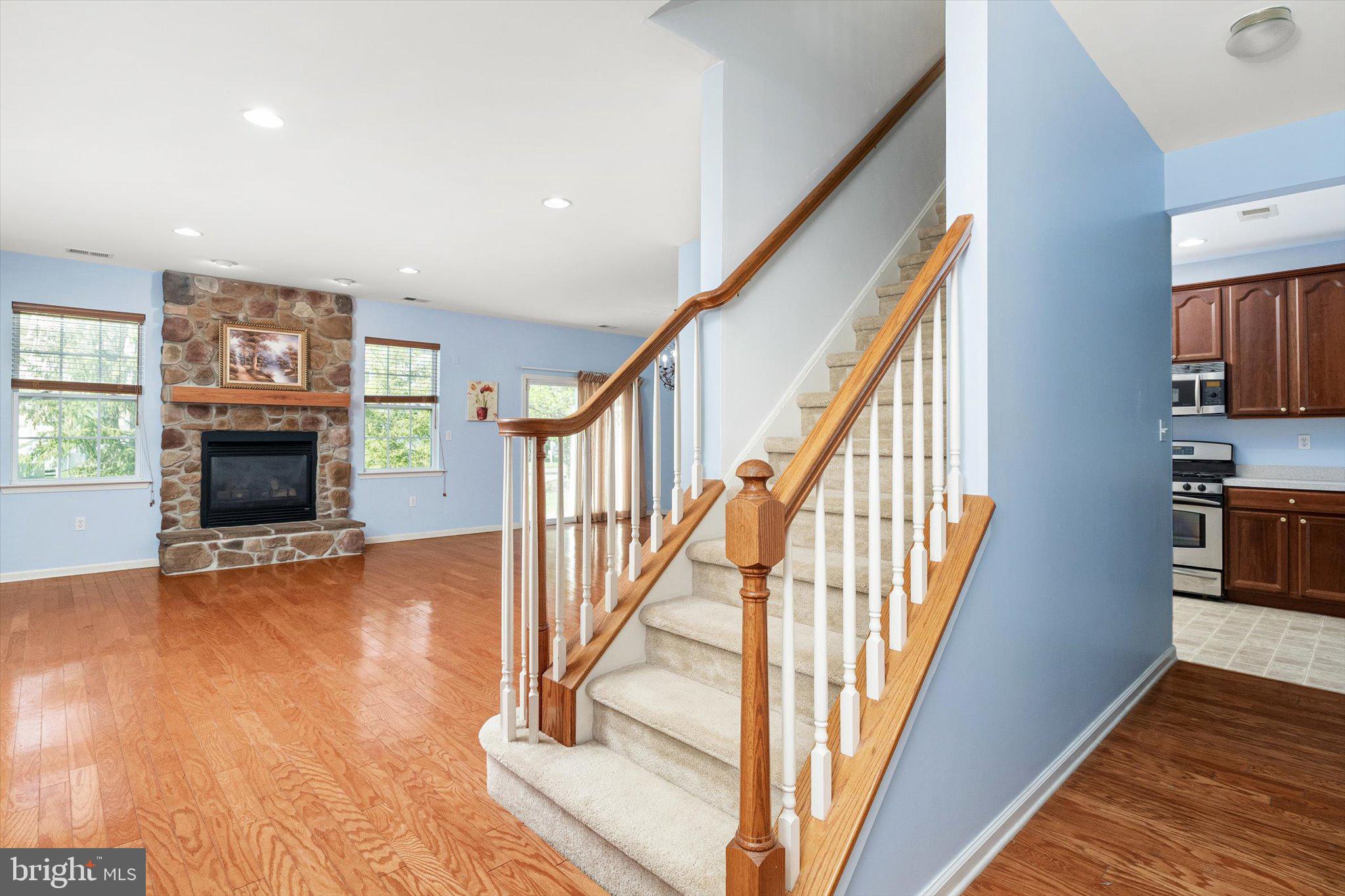 24 Blake Drive Pennington, NJ 08534 - Photo 7 of 28 a view of an empty room with wooden floor fireplace and a window