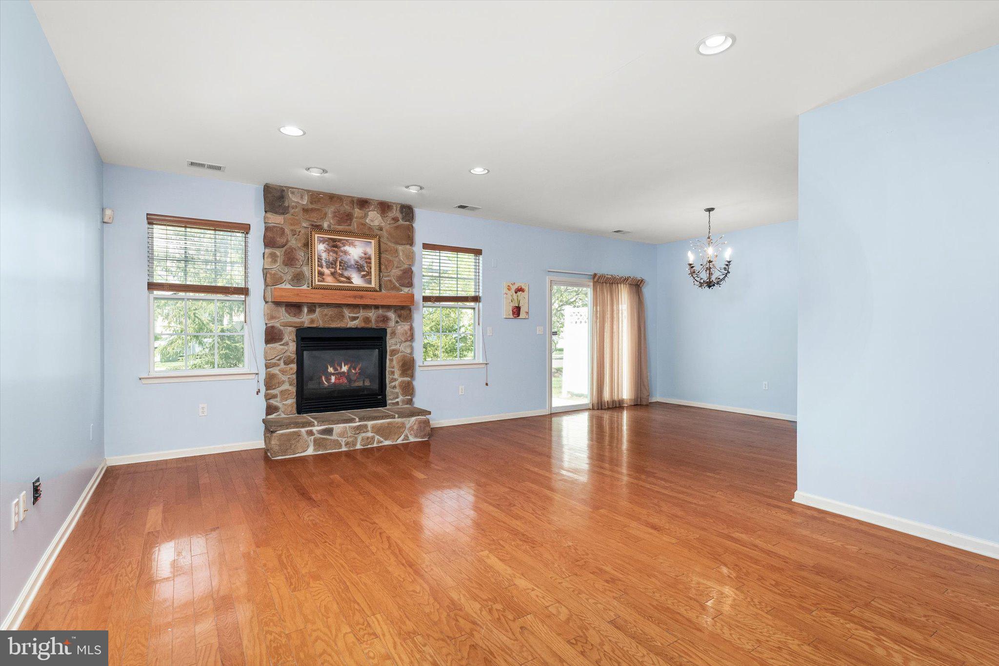 24 Blake Drive Pennington, NJ 08534 - Photo 8 of 28 an empty room with windows and a fireplace