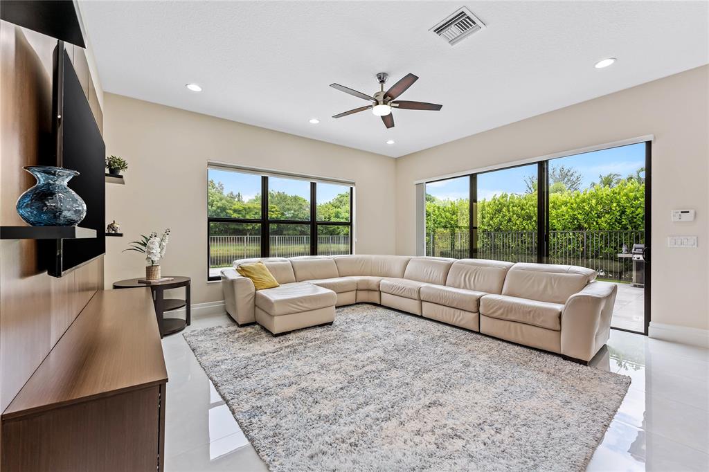 9571 Eden Roc Court Delray Beach, FL 33446 - Photo 14 of 45 a living room with furniture and a large window
