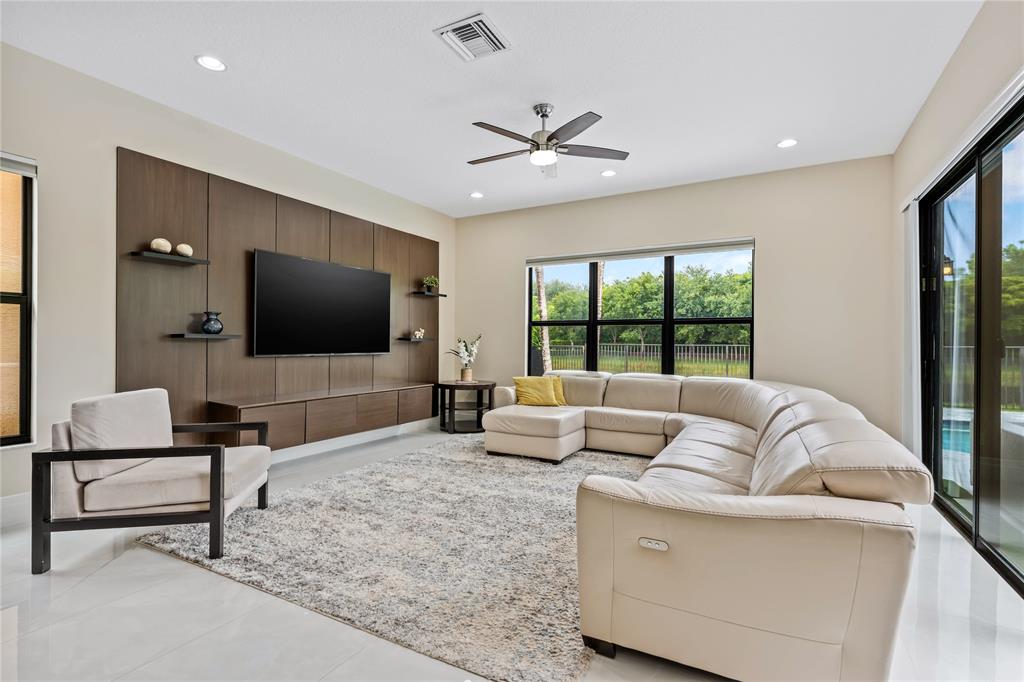 9571 Eden Roc Court Delray Beach, FL 33446 - Photo 15 of 45 a living room with furniture and a flat screen tv