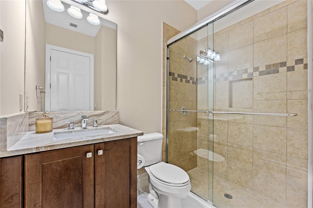 9571 Eden Roc Court Delray Beach, FL 33446 - Photo 18 of 45 a bathroom with a granite countertop sink toilet and shower