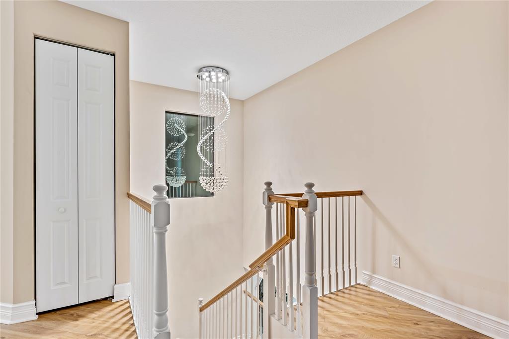 9571 Eden Roc Court Delray Beach, FL 33446 - Photo 19 of 45 a view of a hallway with wooden floor and entryway