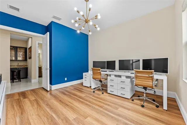 a view of a hallway with wooden floor and entryway