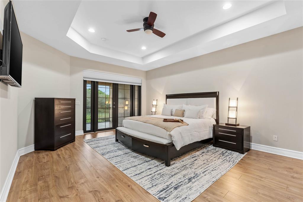 9571 Eden Roc Court Delray Beach, FL 33446 - Photo 22 of 45 a bedroom with a bed and wooden floor