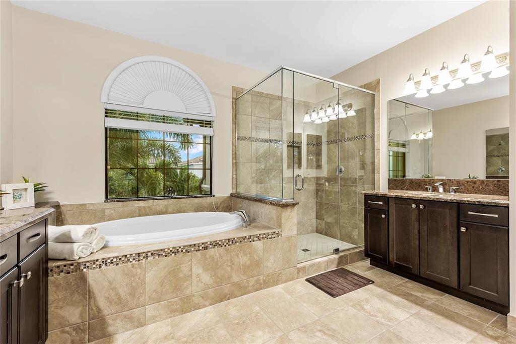 9571 Eden Roc Court Delray Beach, FL 33446 - Photo 26 of 45 a spacious bathroom with a tub sink and mirror